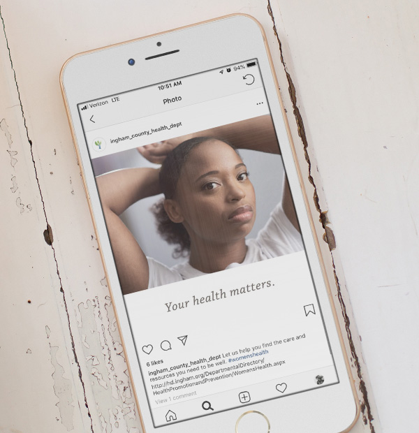Phone featuring a social post from the campaign